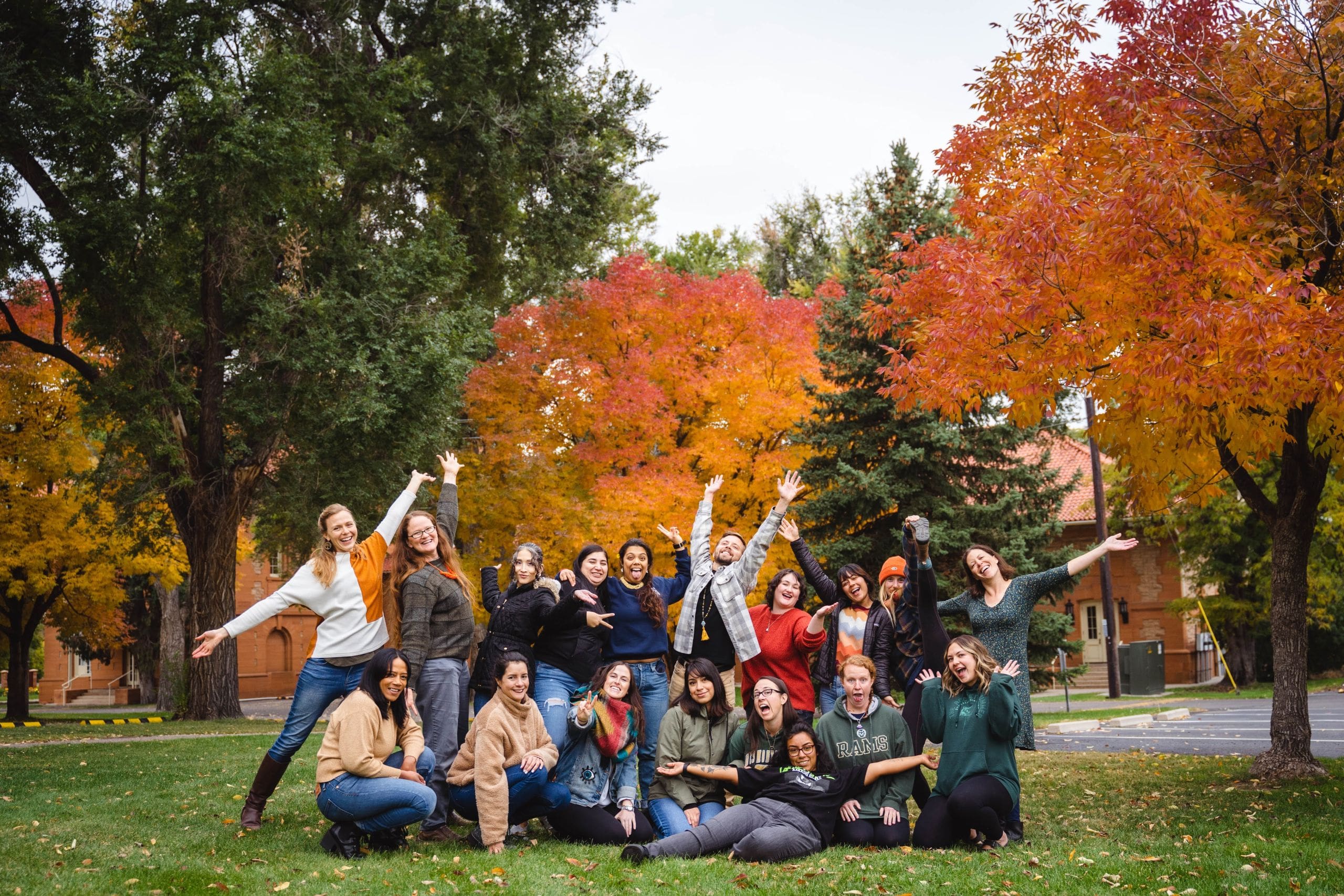 a group of cheerful MECR students against a fall background